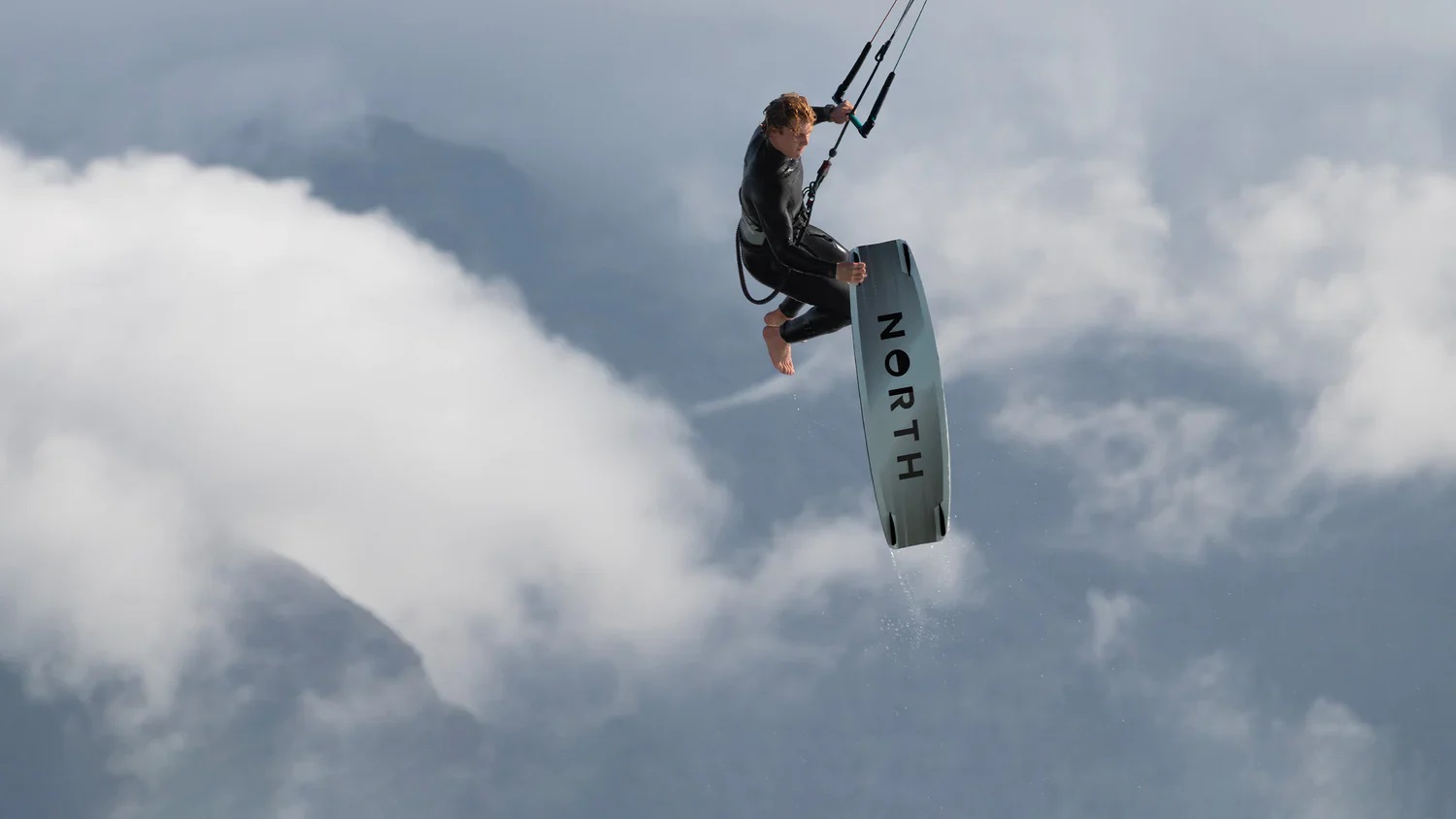 board-off trick high in the air during a big air kitesurf session