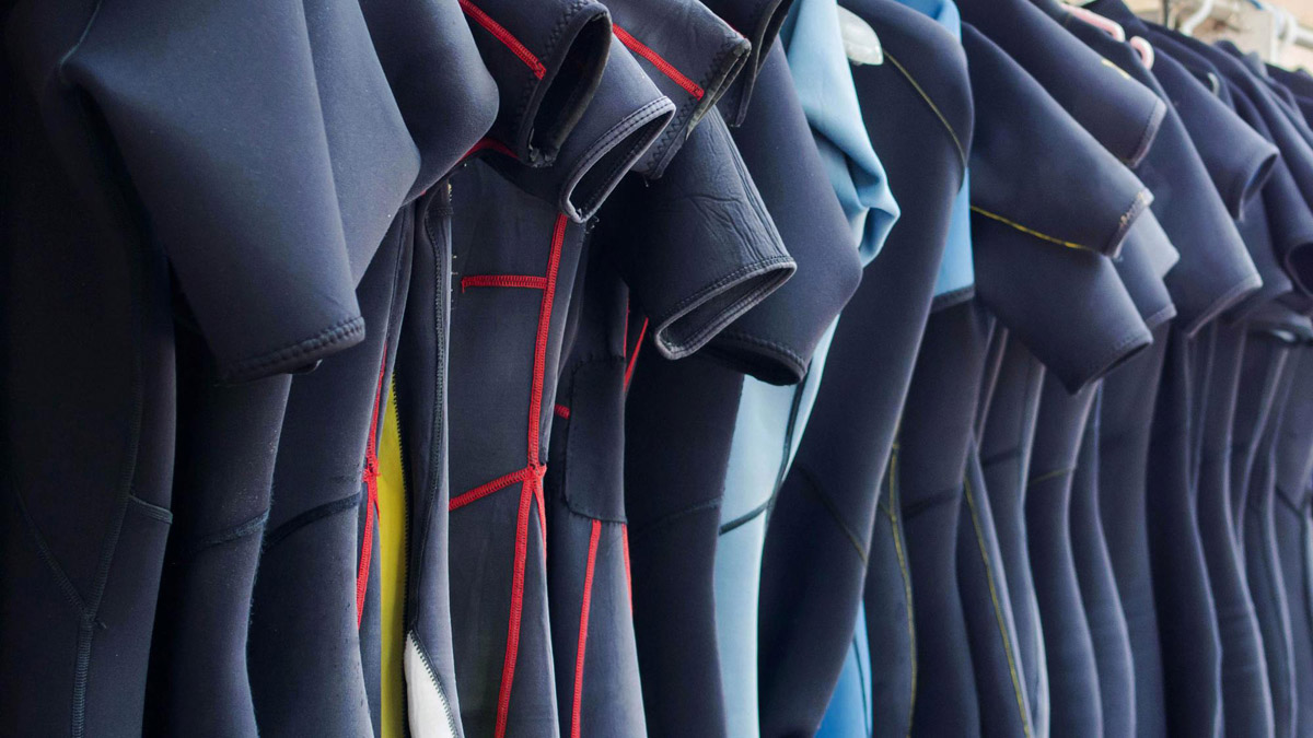wetsuits hanging for drying and storage